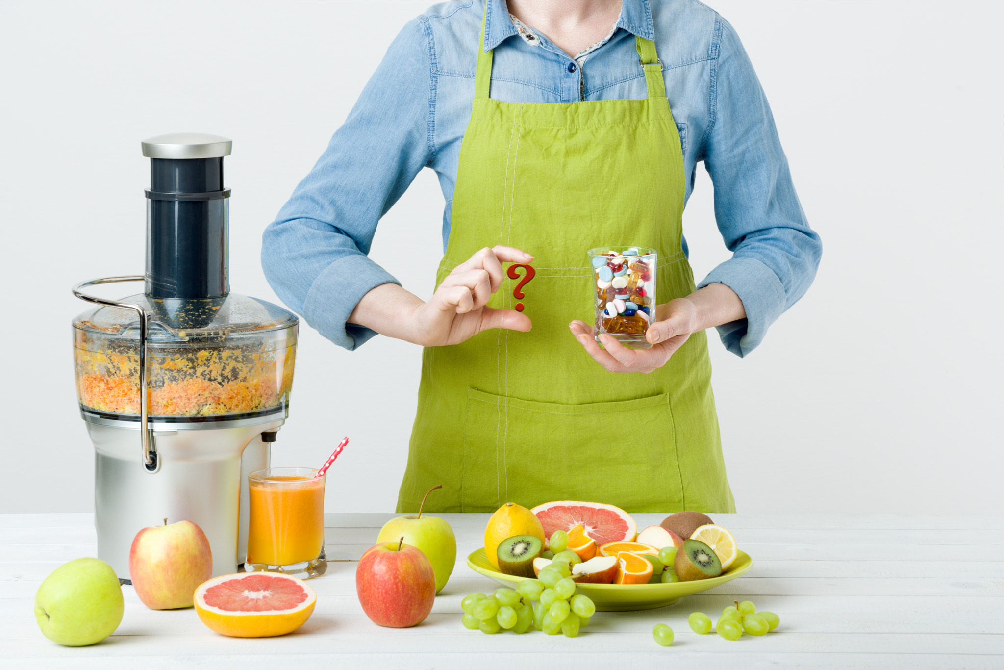 Healthy lifestyle and diet concept. Fruit juice, pills and vitamin supplements, woman making a...