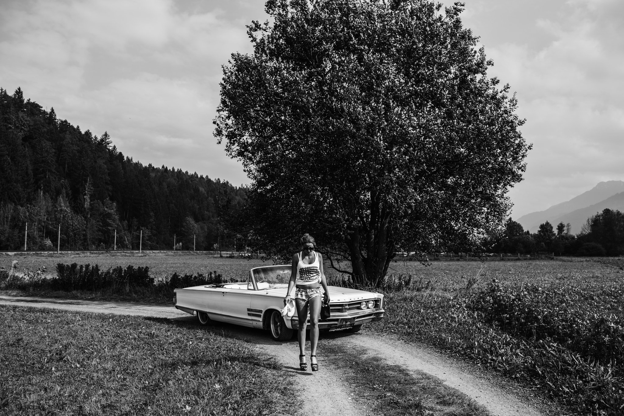 Sony a7R II + Canon EF 35mm F1.4L USM sample photo. Old chrysler and girl walking photography
