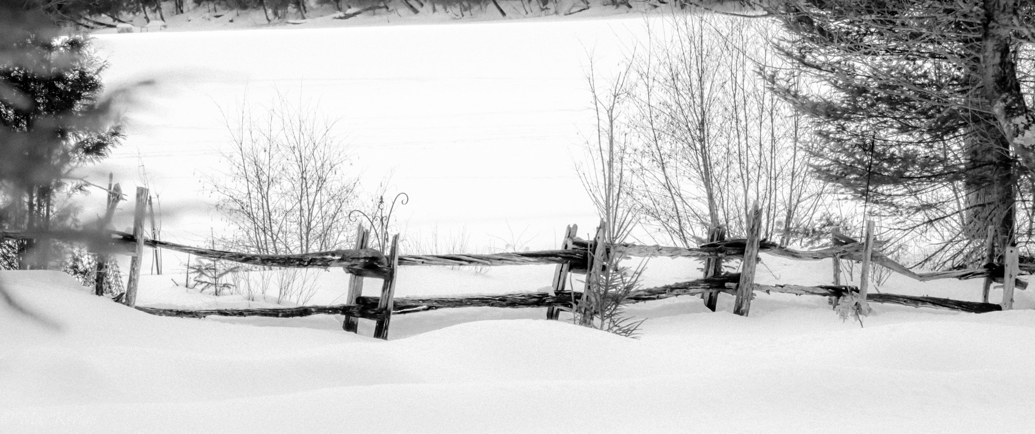Sony Alpha NEX-7 + Sony E 55-210mm F4.5-6.3 OSS sample photo. Old fence next to frozen lake photography