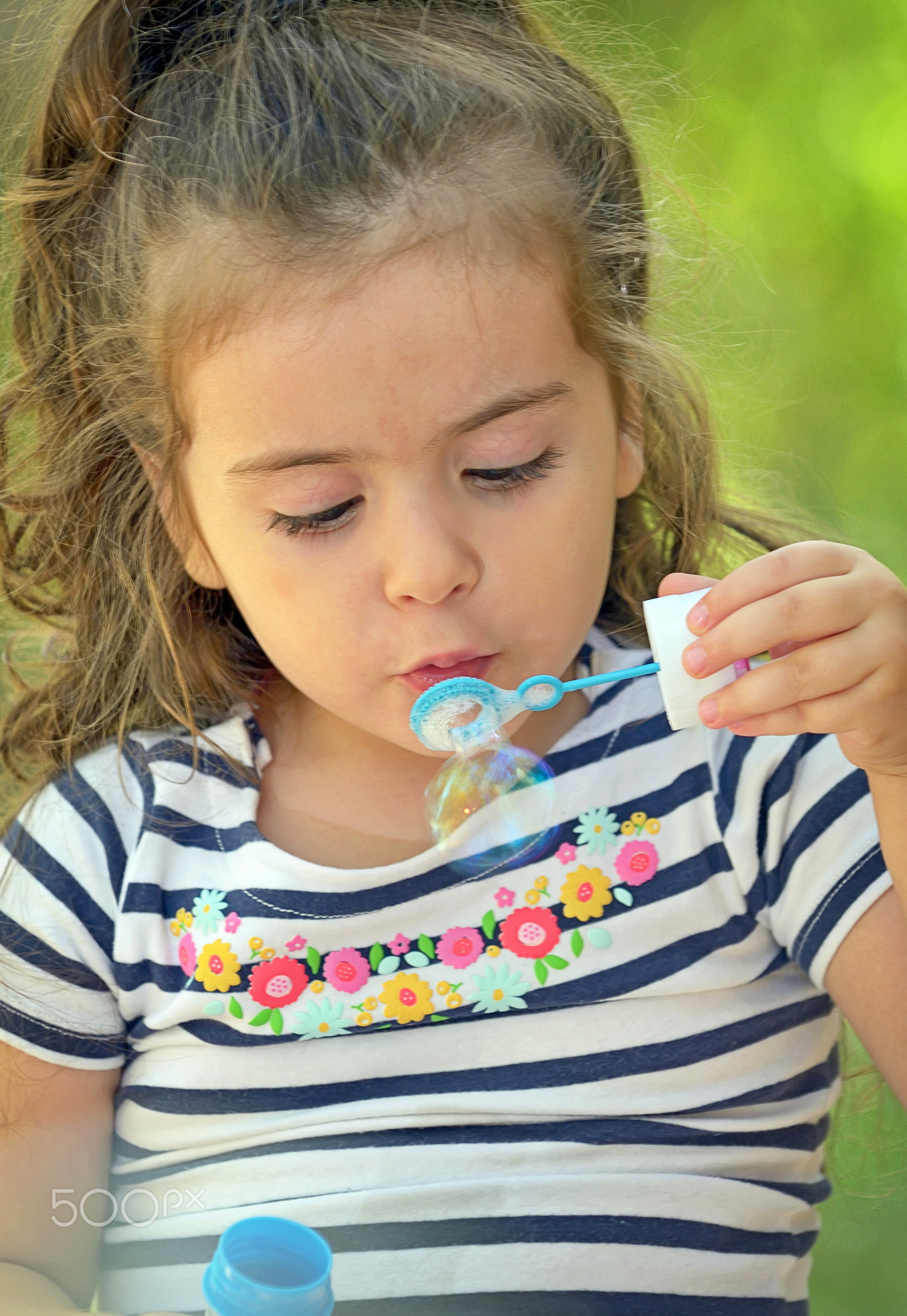 Child blowing soap bubbles