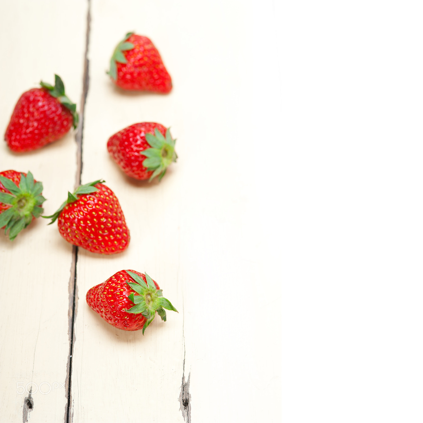 Nikon D700 + AF Micro-Nikkor 105mm f/2.8 sample photo. Fresh organic strawberry over white wood photography