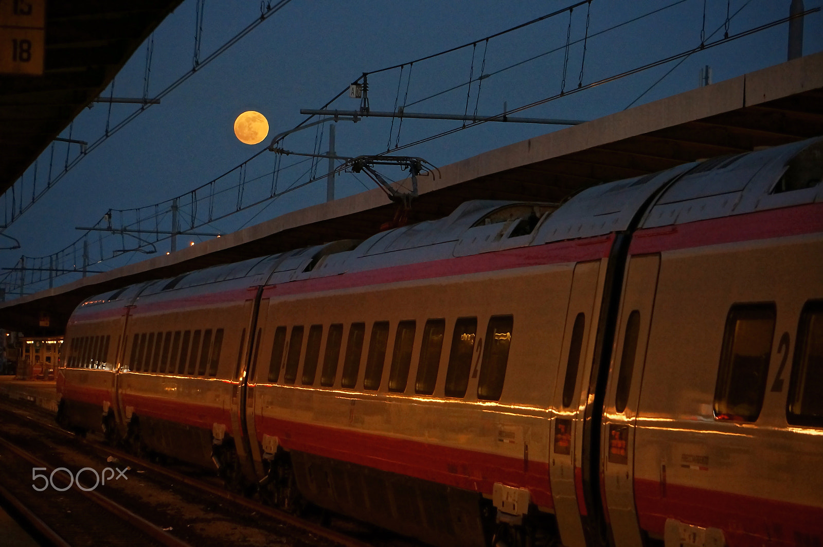 Sony Alpha NEX-5N + Sony E 55-210mm F4.5-6.3 OSS sample photo. Red moon in the train station photography