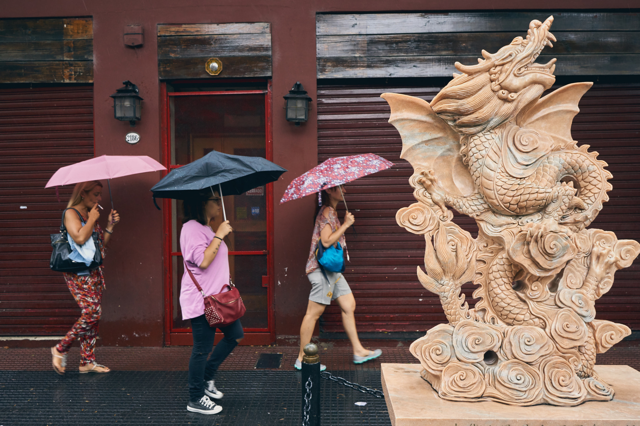 Sony E 20mm F2.8 sample photo. Women with umbrellas and dragon photography