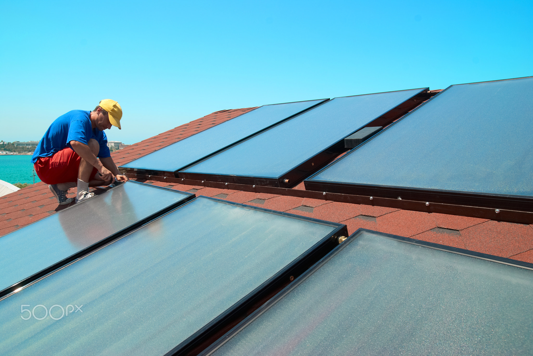 Worker installs solar panels