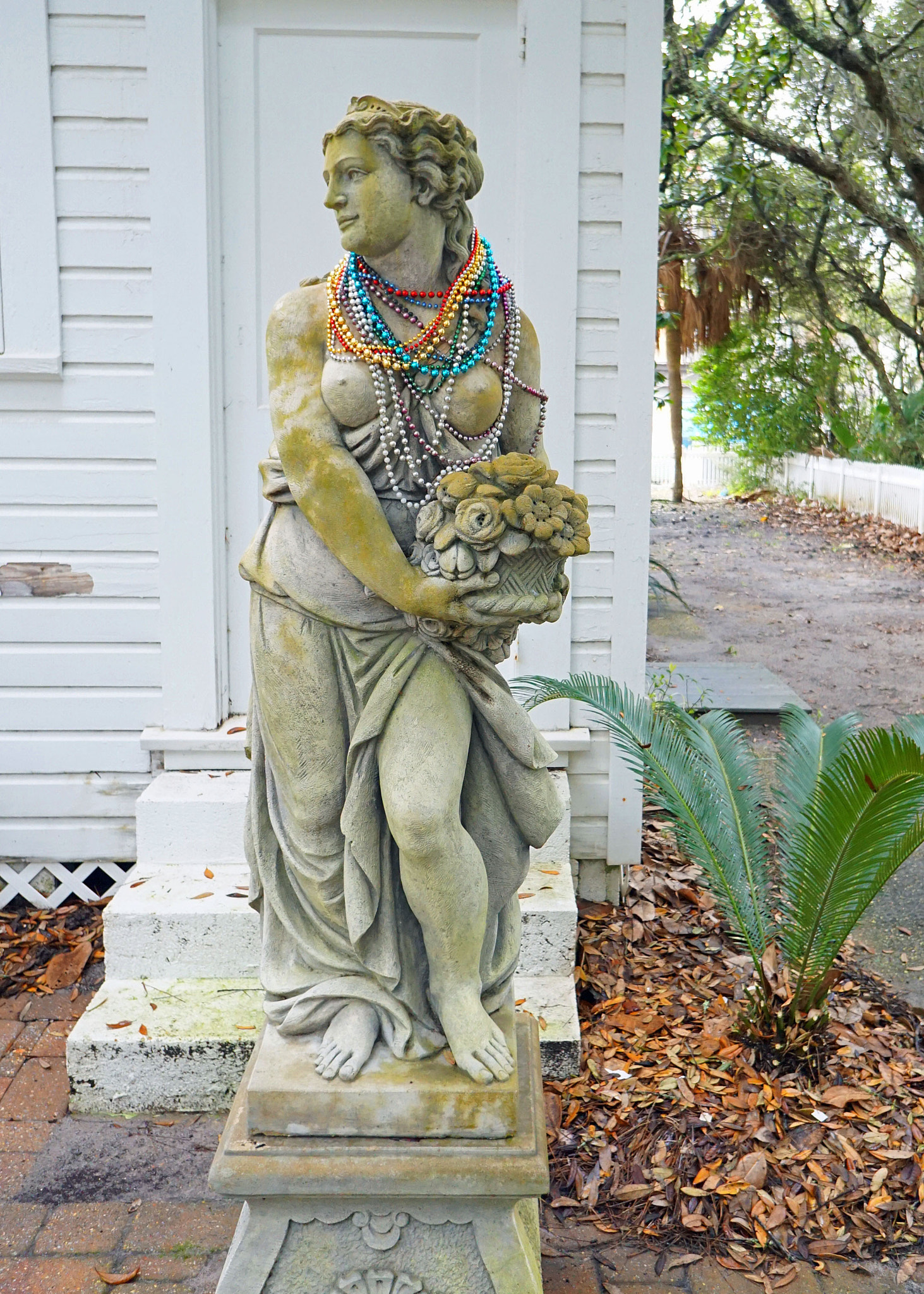 Sony a6000 + Sony E 16mm F2.8 sample photo. Statue with beads photography