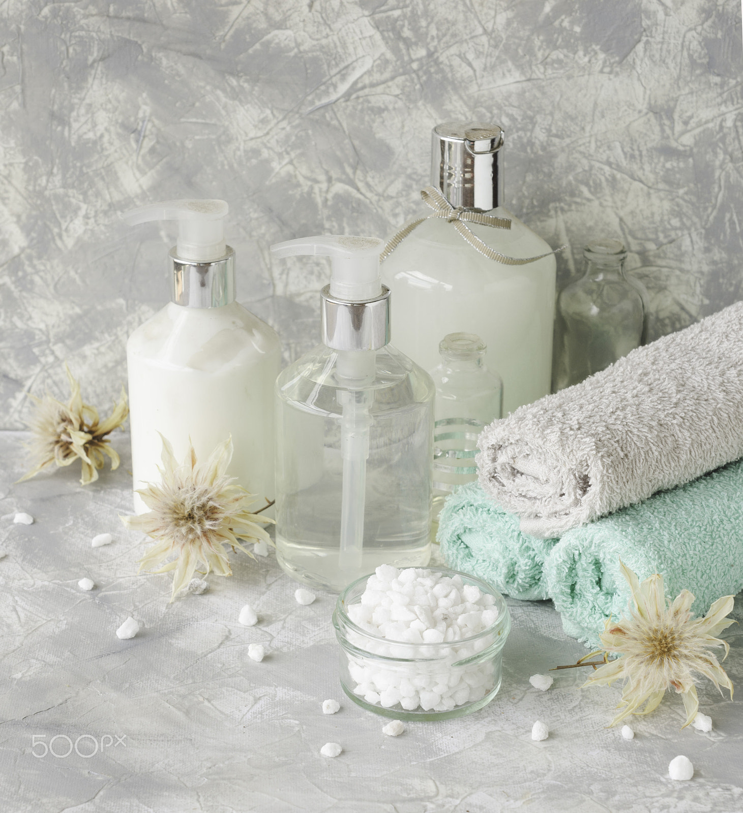 Nikon D7000 sample photo. Spa set on a white marble table with a stack of towels, selective focus photography