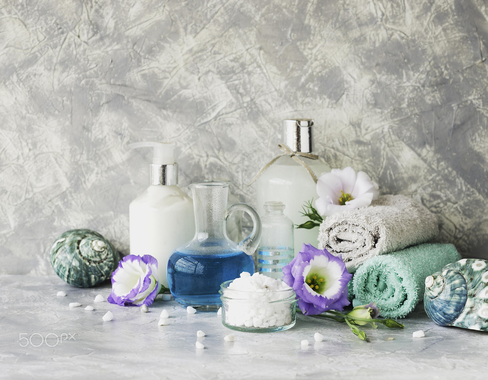 Nikon D7000 sample photo. Spa set on a white marble table with a stack of towels, selective focus photography