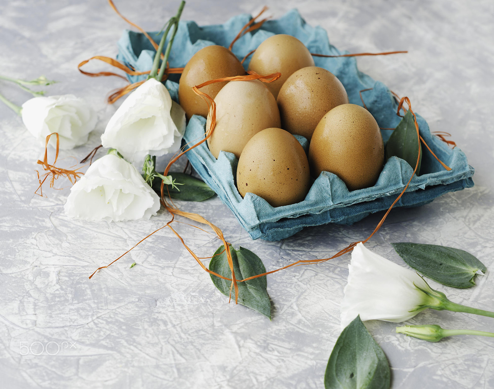 Nikon D7000 + Nikon AF-S DX Micro Nikkor 40mm F2.8 sample photo. Raw eggs in a carton for eggs with white flowers on a marble white table, ready for painting... photography