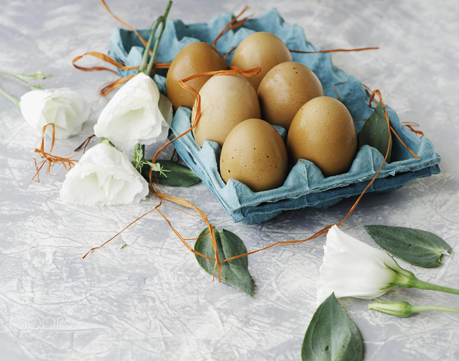 Nikon AF-S DX Micro Nikkor 40mm F2.8 sample photo. Raw eggs in a carton for eggs with white flowers on a marble white table, ready for painting... photography