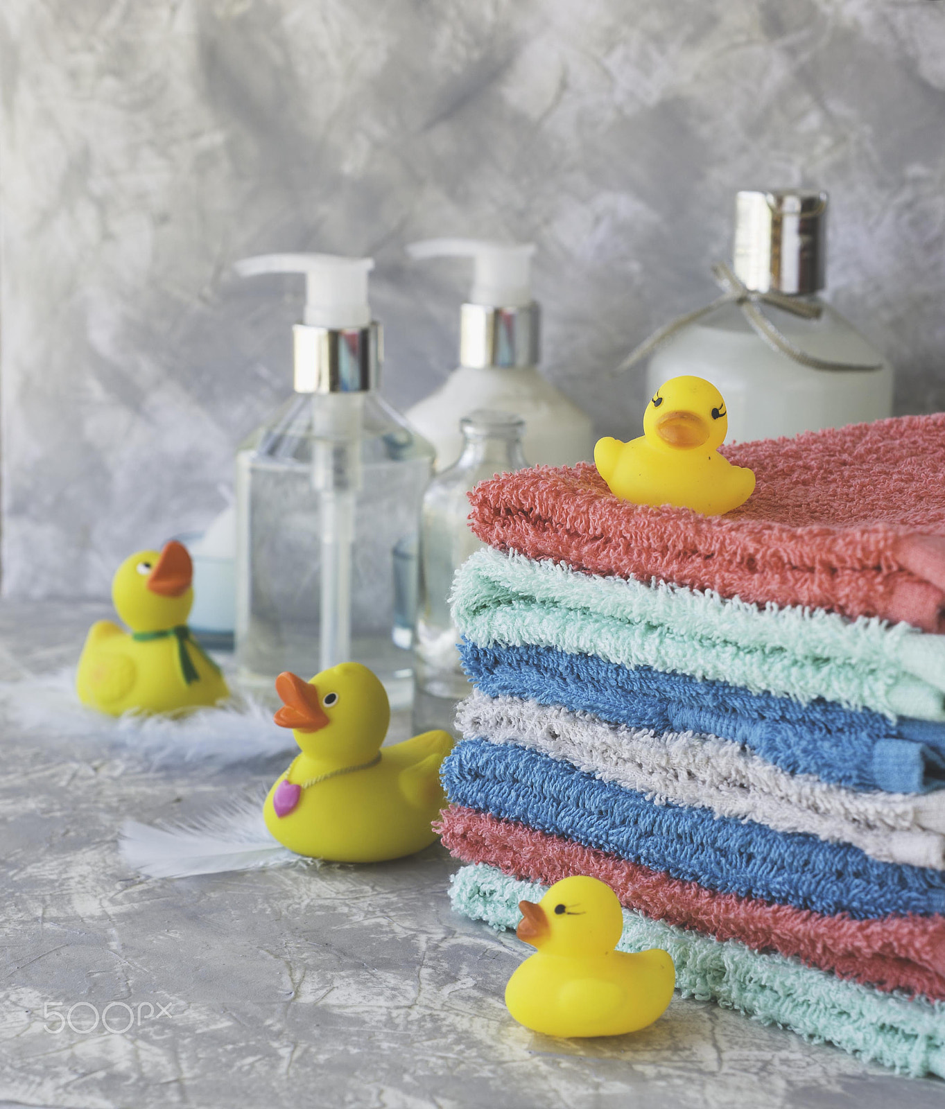 Nikon AF-S DX Micro Nikkor 40mm F2.8 sample photo. Stack of towels with yellow rubber bath ducks on white marble background, space for text,... photography
