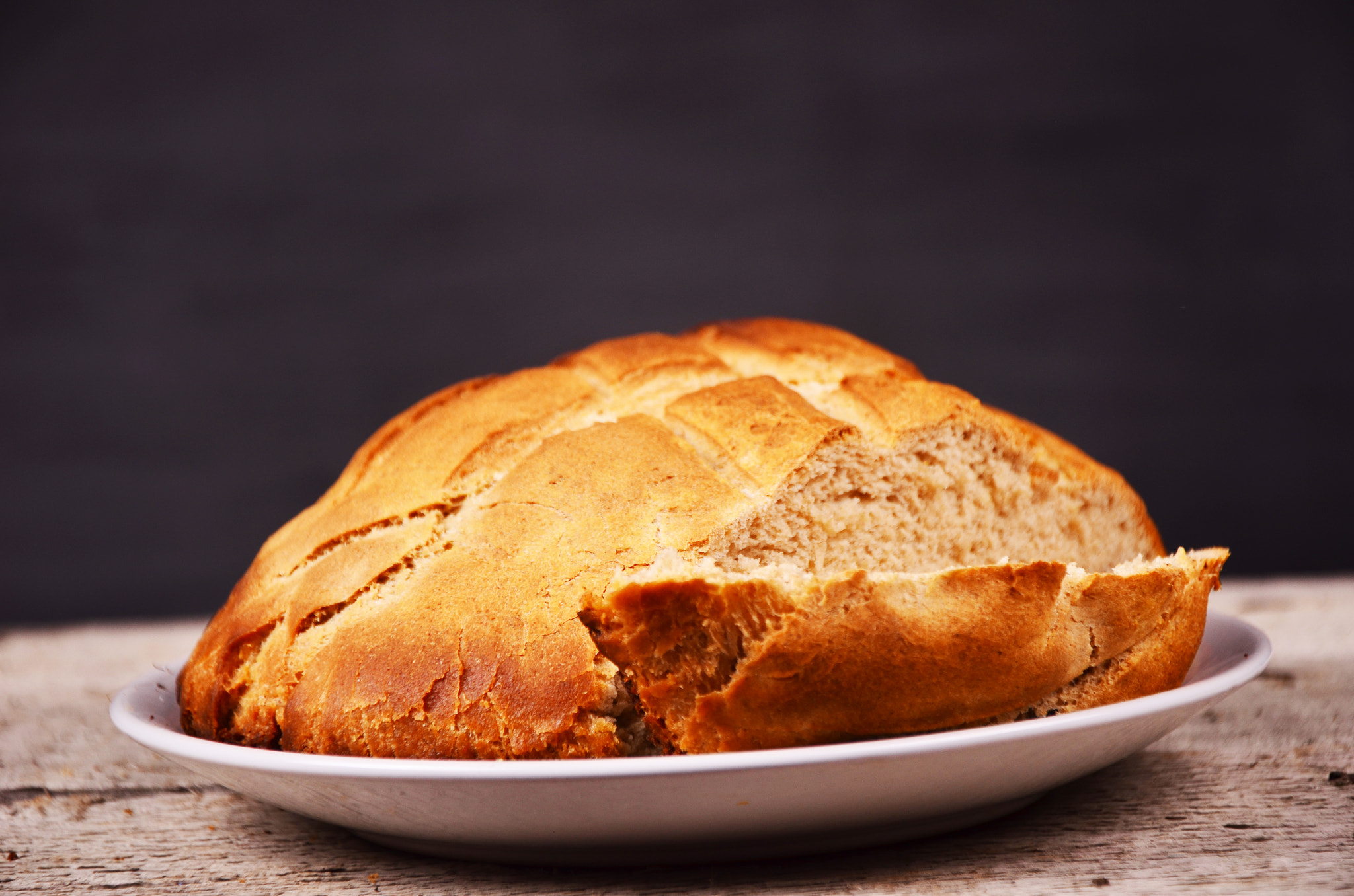 Traditional homemade round bread on a black background