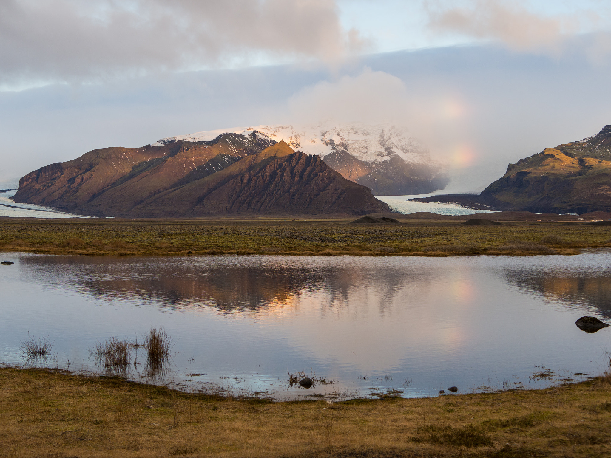 Olympus OM-D E-M10 II + LUMIX G 25/F1.7 sample photo. Rainbow above glacier photography