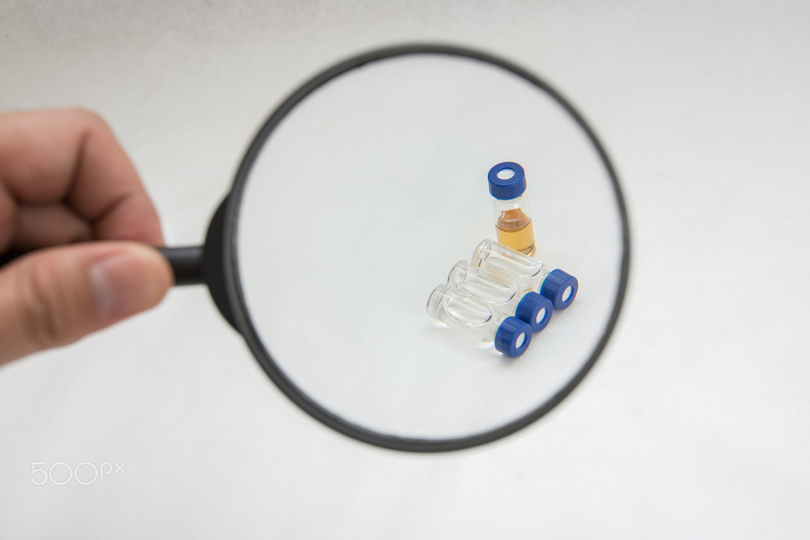 Nikon AF-S Nikkor 16-35mm F4G ED VR sample photo. Handing magnify glass on sample vial photography