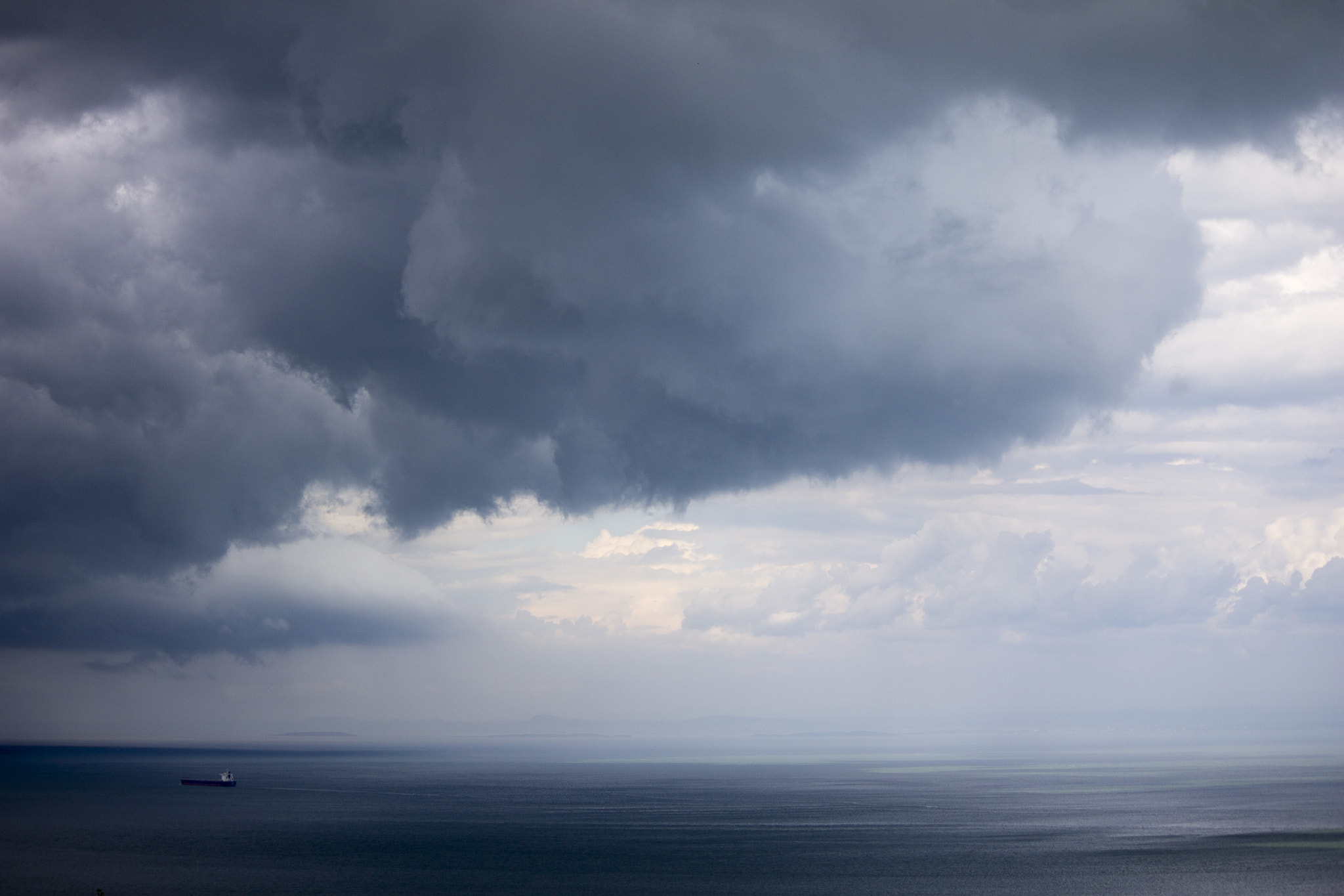 Canon EOS 1100D (EOS Rebel T3 / EOS Kiss X50) sample photo. Boat heading into a storm on the st-lawrence river photography