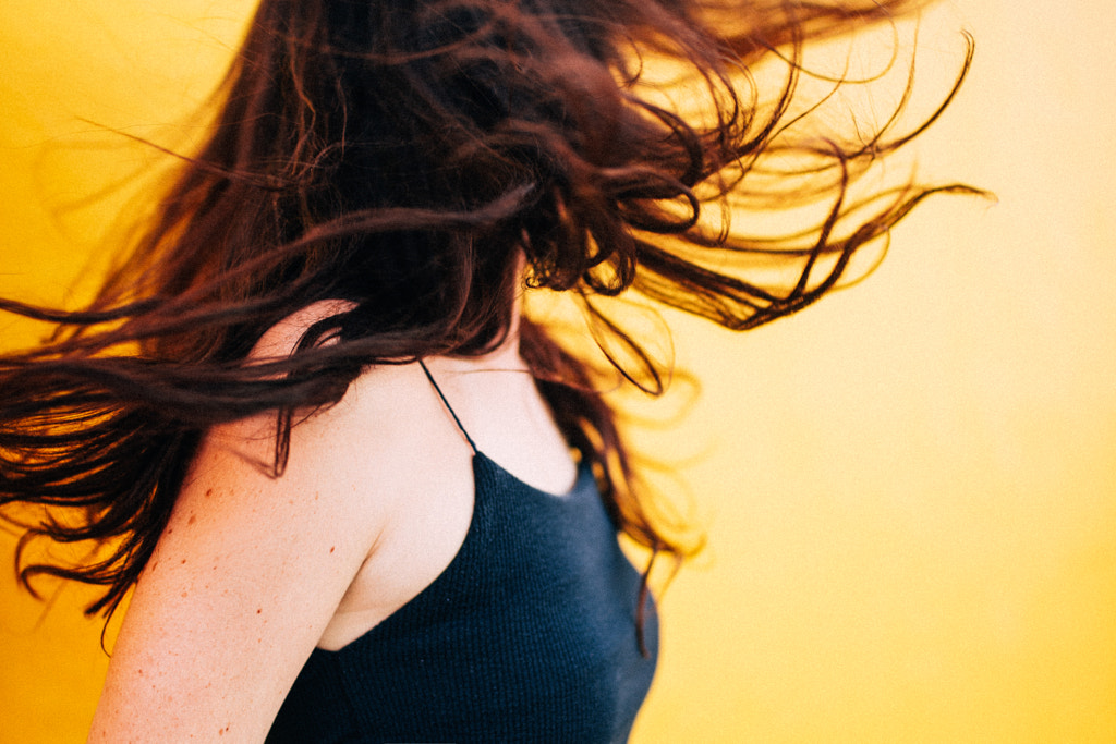Women shaking her head and letting her hair blow by Carina König on 500px.com