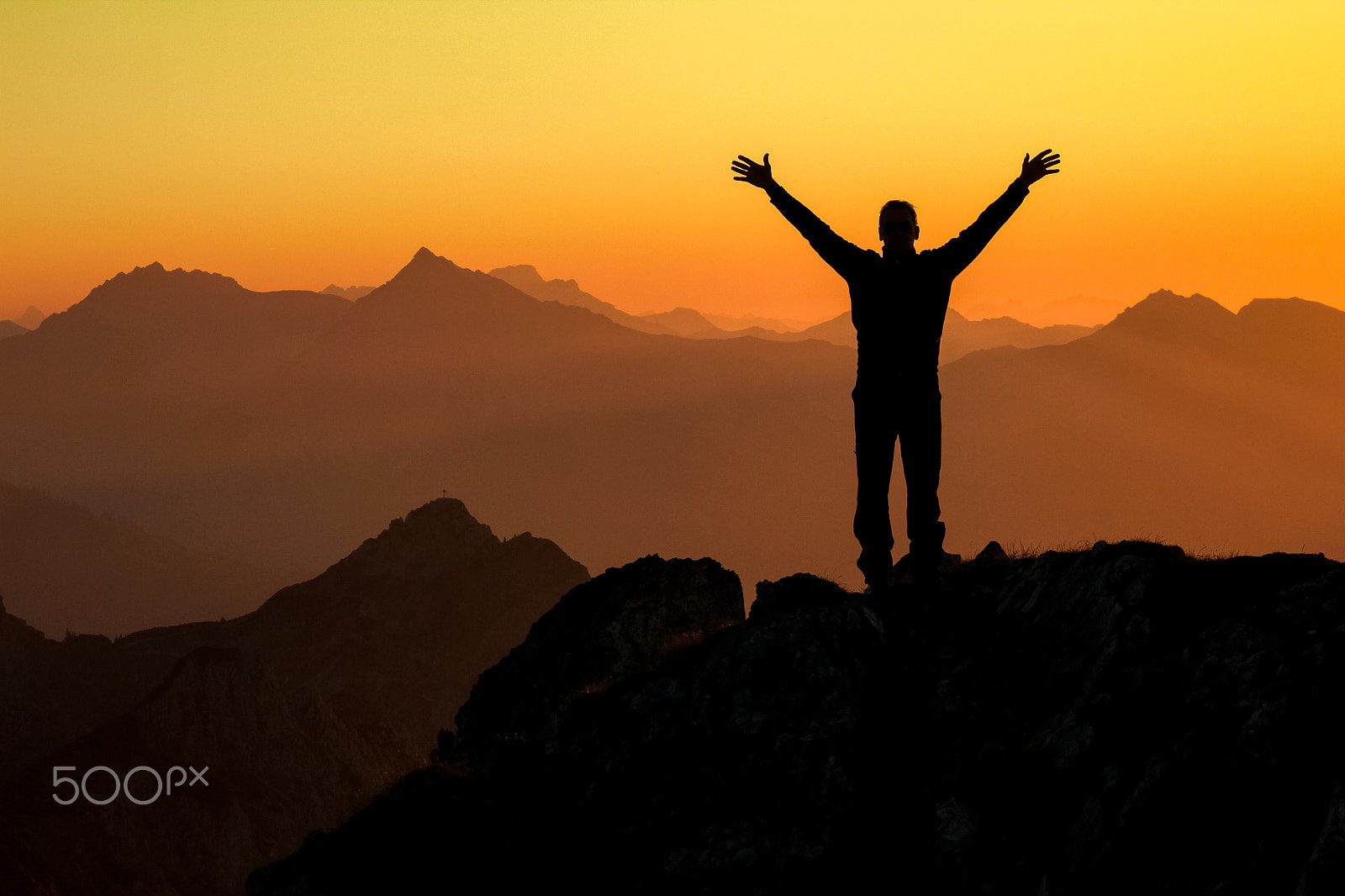 Canon EOS 550D (EOS Rebel T2i / EOS Kiss X4) sample photo. Happy success winning man on summit arms up at sunset photography