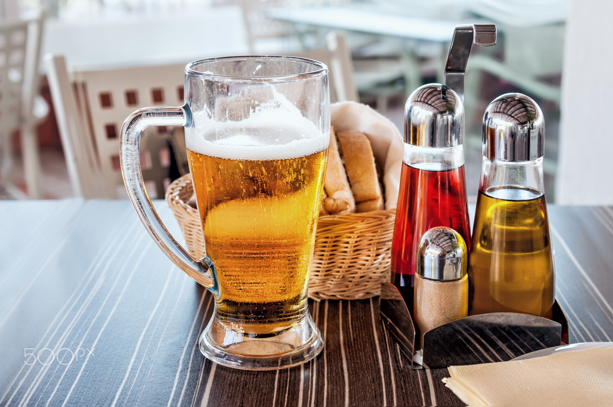 Beer in the glass on the table with serving