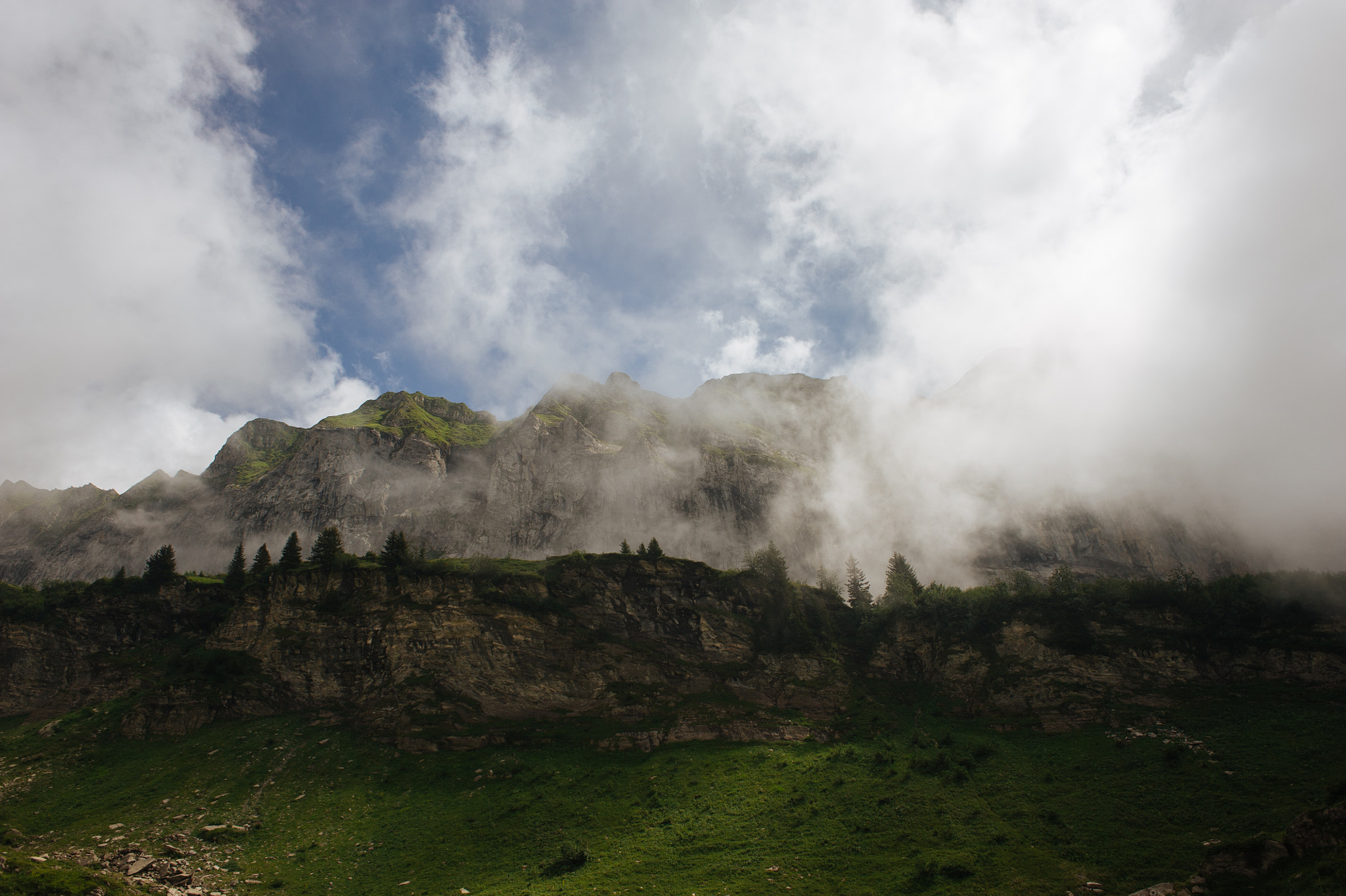 Nikon D700 + Nikon AF Nikkor 24mm F2.8D sample photo. The clouds meet the cliff photography