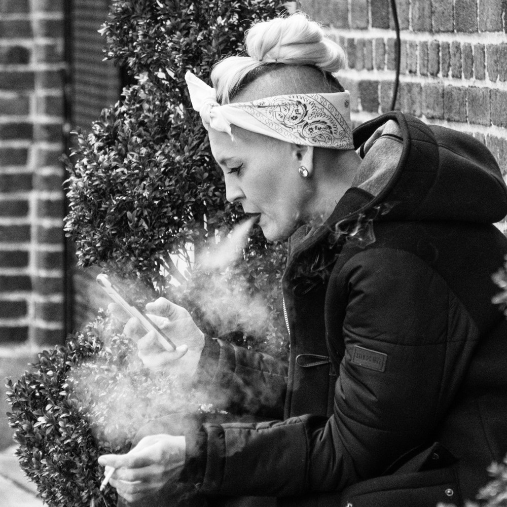 Sony a6300 + Sony E 55-210mm F4.5-6.3 OSS sample photo. Smoking woman photography