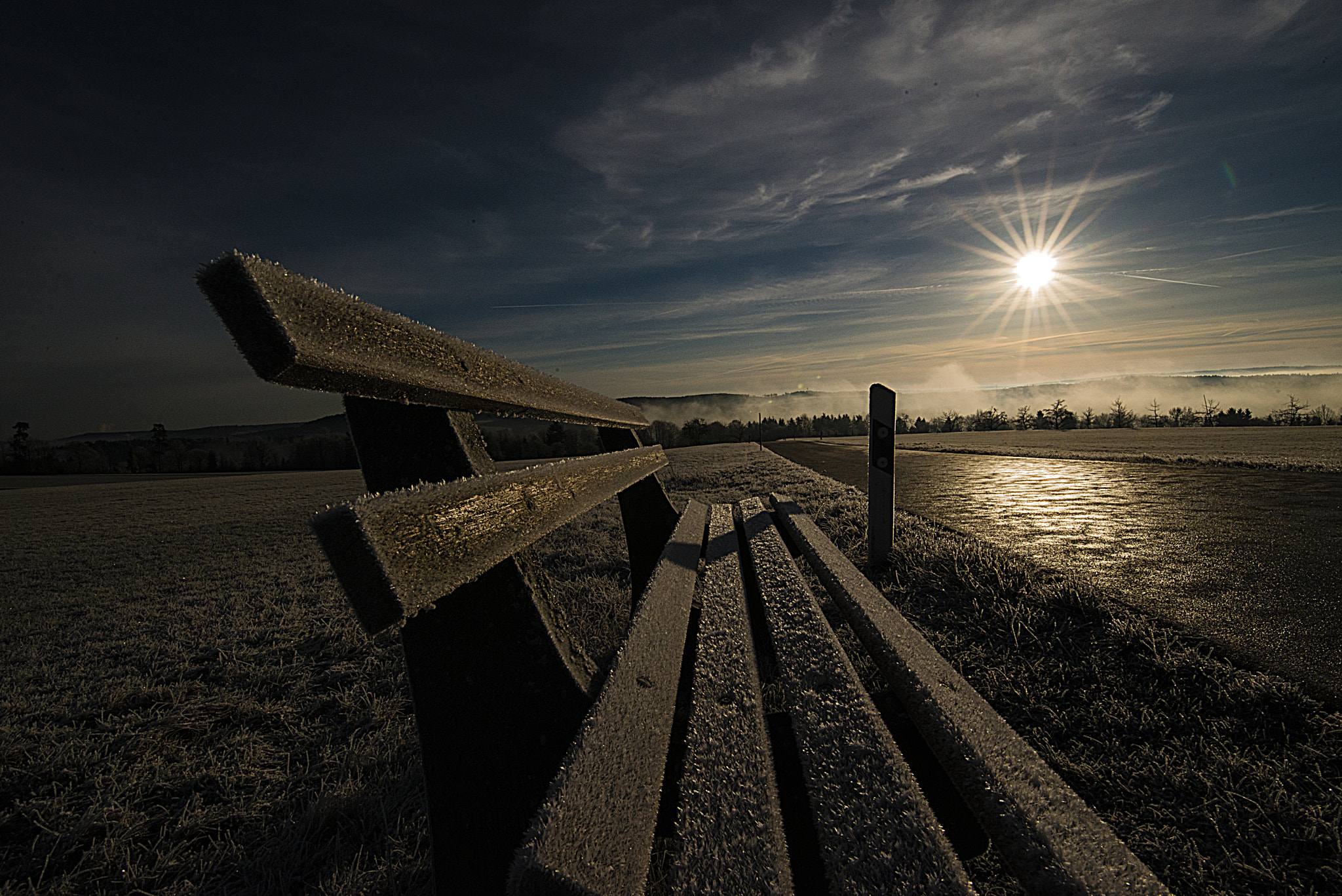 Tamron SP 15-30mm F2.8 Di VC USD sample photo. Icy bench and road and the sun photography