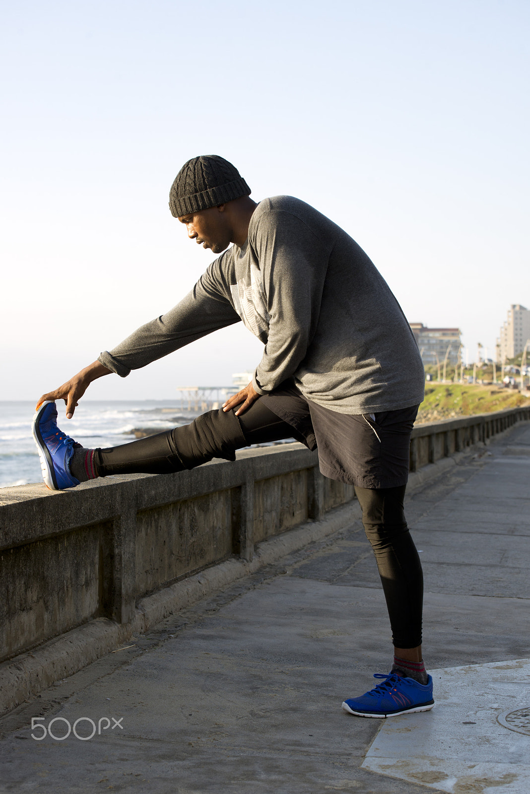 Nikon D600 sample photo. Jogger doing stretches by the side of the road photography