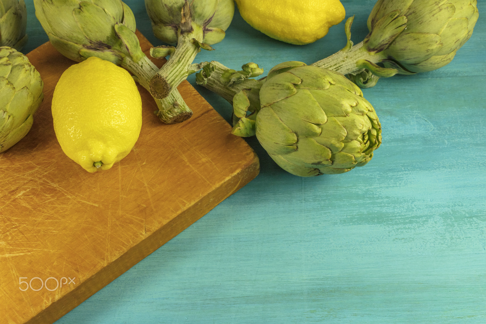Canon EOS 5DS R + Canon EF 50mm F1.4 USM sample photo. Artichokes and lemons on vibrant turquoise with copyspace photography