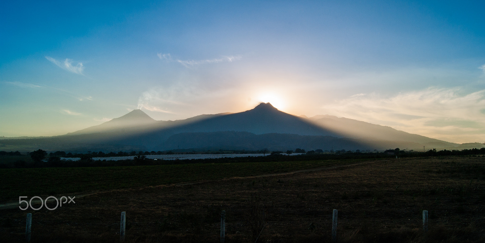 Sony Alpha DSLR-A380 sample photo. Sun setting behind the peak photography