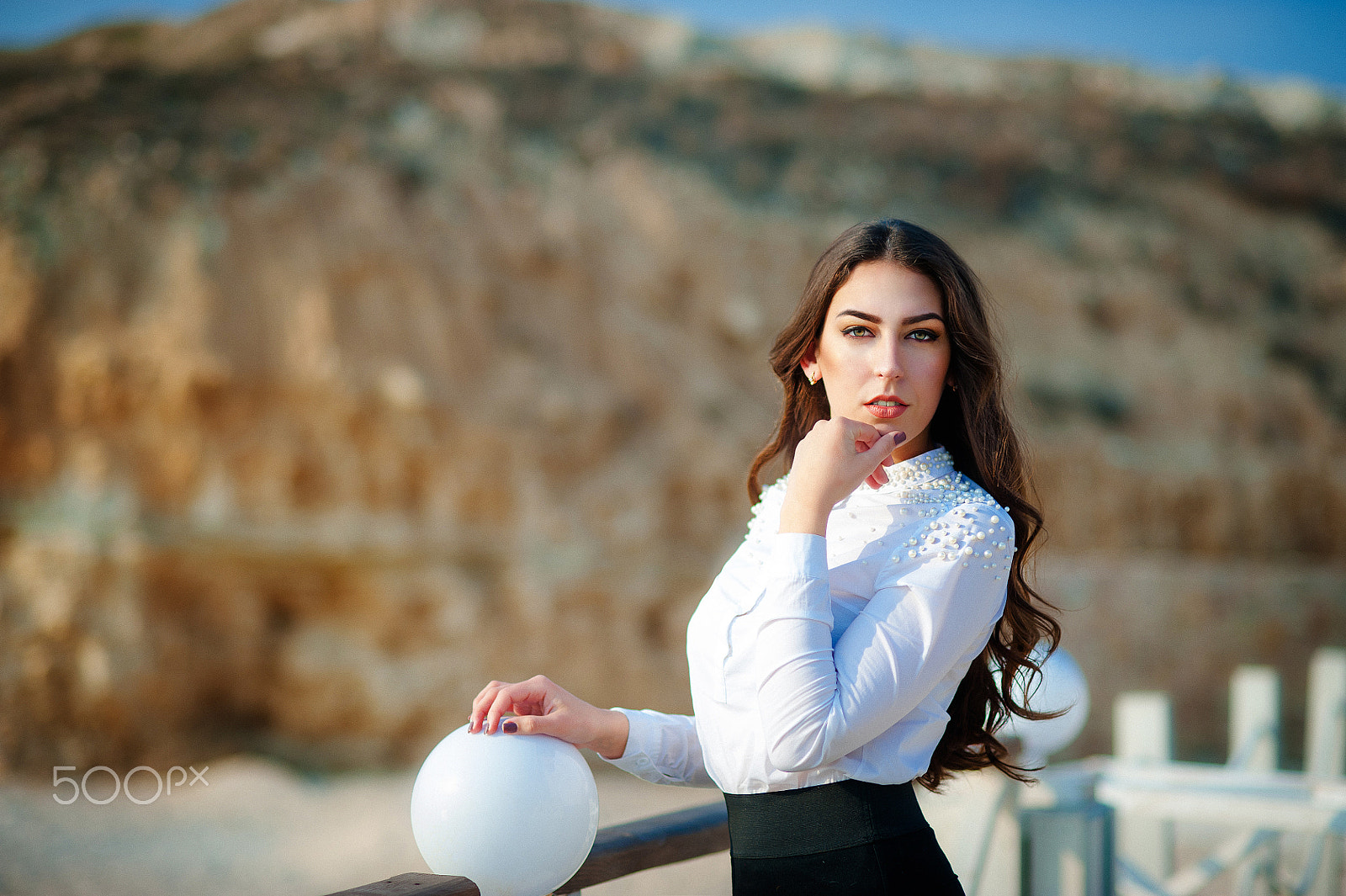 Nikon D700 + Nikon AF Nikkor 85mm F1.8D sample photo. Beautiful young woman close-up in white blouse, against the backdrop of the mountains photography