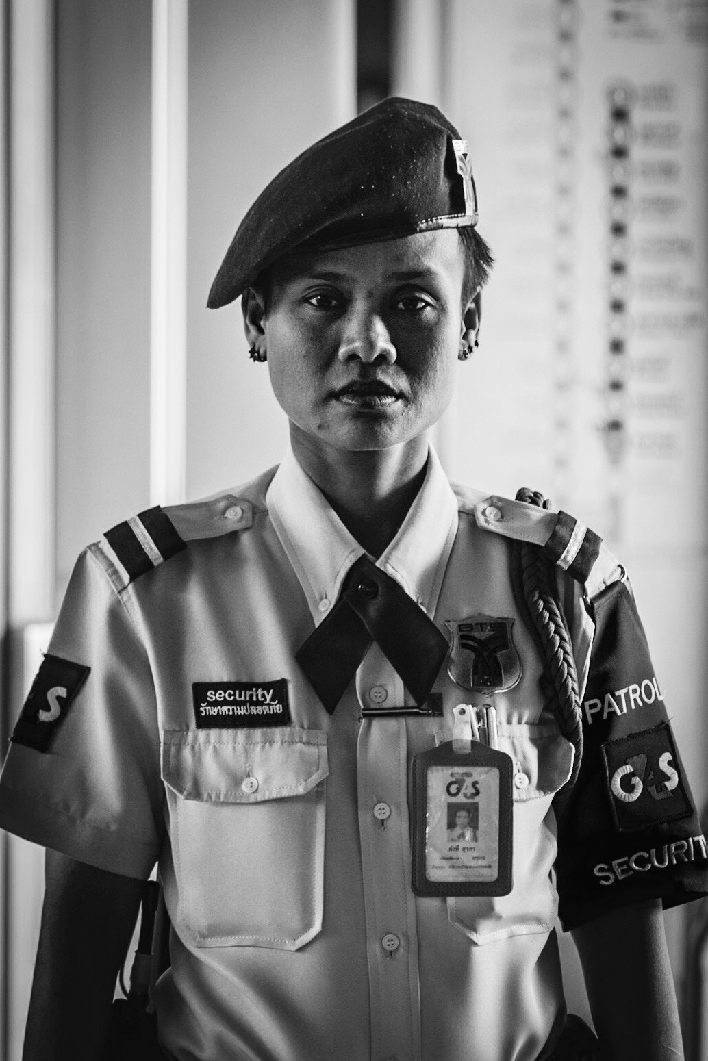 Canon EF 70-300mm F4-5.6 IS USM sample photo. A female guard working as security on the bangkok sky train system. photography
