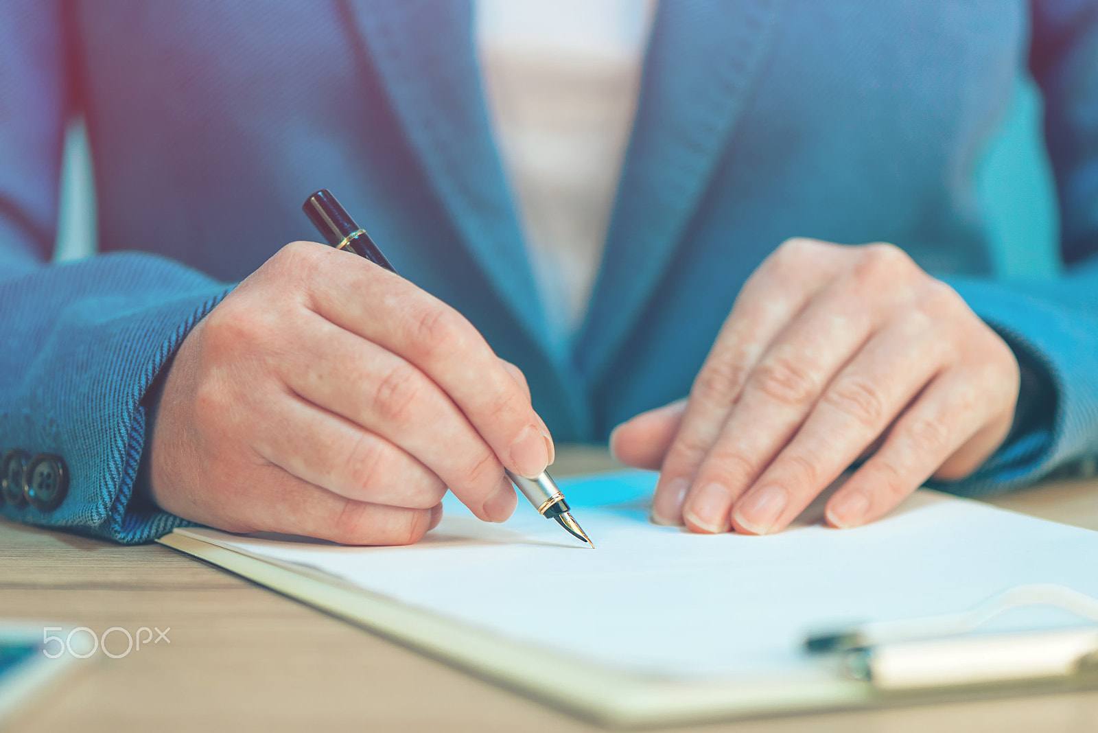 Nikon AF-S Micro-Nikkor 105mm F2.8G IF-ED VR sample photo. Close up of female hands writing signature on business agreement photography