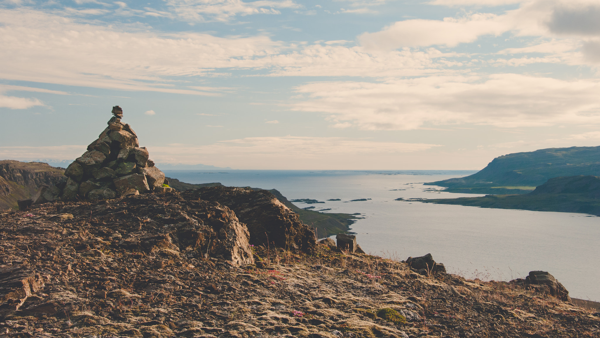 Pentax K20D sample photo. Ancient rock cairn overlooking icelandic fjords. photography