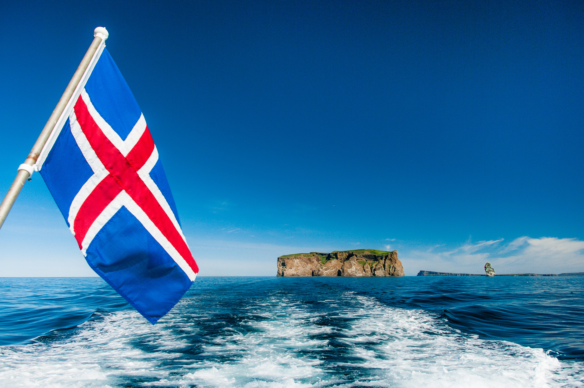 Pentax smc DA 18-250mm F3.5-6.3 sample photo. Icelandic flag with drangey island in distance. photography