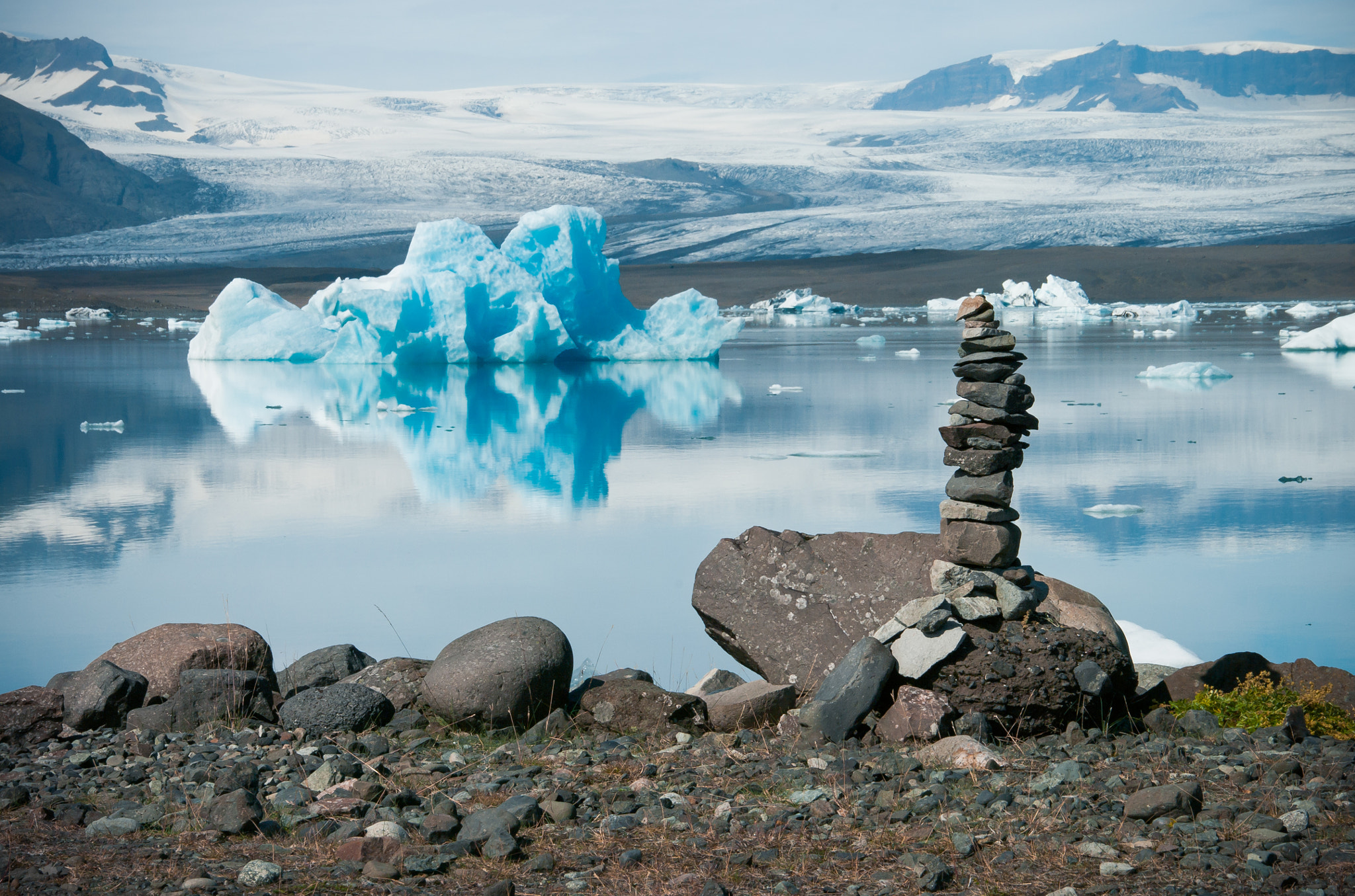 Pentax smc DA 18-250mm F3.5-6.3 sample photo. Rock cairn in front of blue iceberg and glacier photography