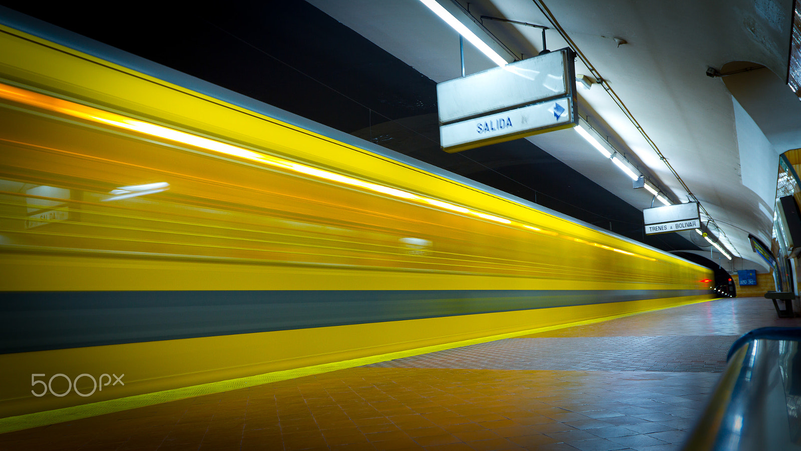 Canon EOS 7D + Canon EF 16-35mm F2.8L II USM sample photo. Bright yellow motion blur of a moving train photography
