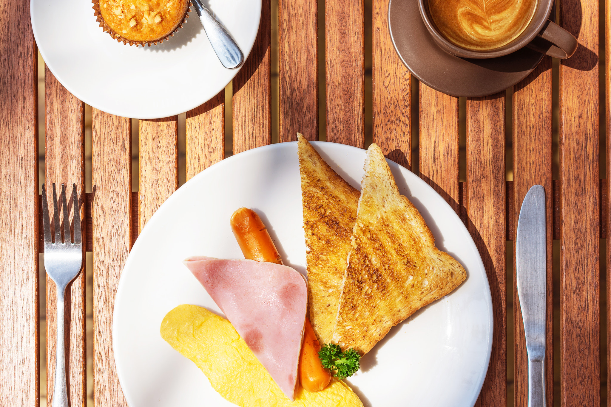 Sony a7R sample photo. American breakfast with a cupcake and cappuccino on a wood table. top view. photography