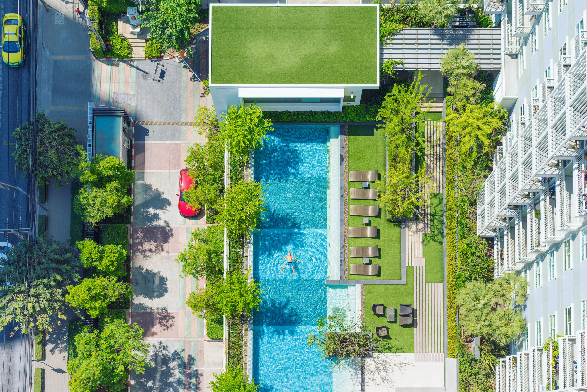 Sony a7R sample photo. Man resting in the swimming pool. bangkok downtown. aerial shoot. photography
