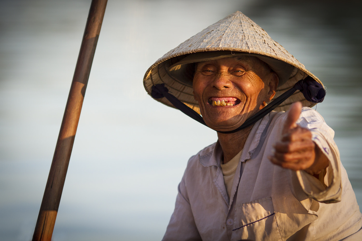 Canon EOS 7D + Canon EF 135mm F2L USM sample photo. Smiling hoi an boat owner in vietnam photography