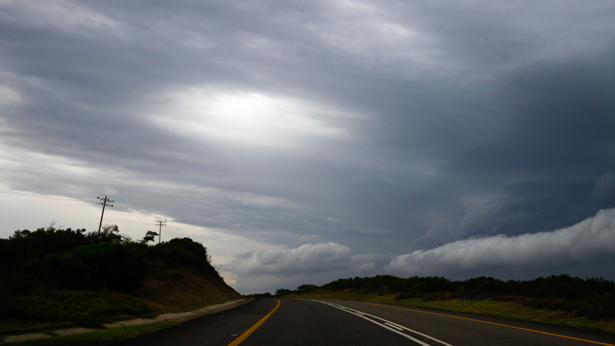 Canon EF 300mm f/2.8L sample photo. White clouds on the road with bushes photography