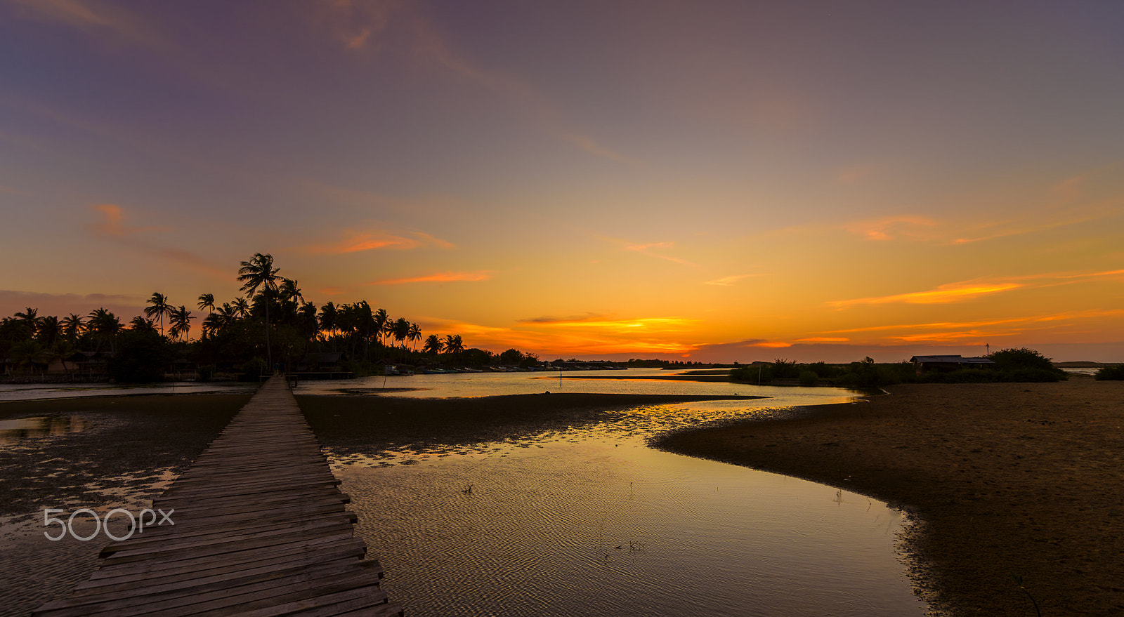 Nikon D810 + Tokina AT-X 16-28mm F2.8 Pro FX sample photo. Sunset sky over a wooden bridge and water in kalpitiya sri lanka photography