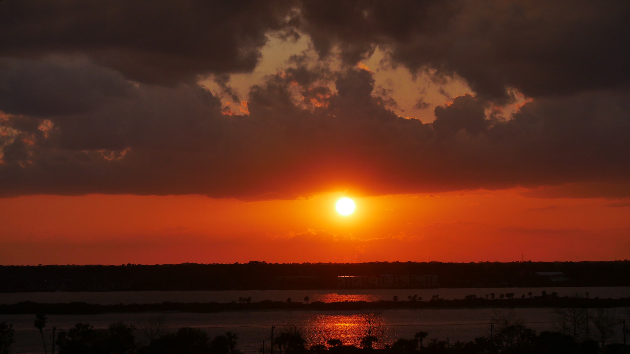 Panasonic Lumix G Vario 45-200mm F4-5.6 OIS sample photo. As the sun goes down, the clouds show blue sky. photography