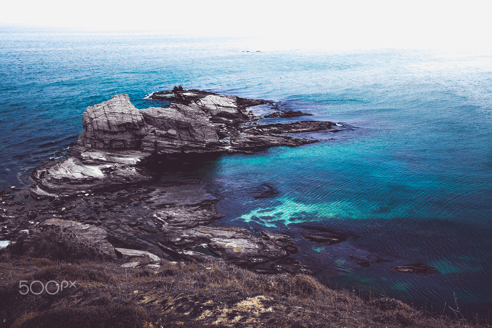 Sony Sonnar T* E 24mm F1.8 ZA sample photo. Dark rocks and the blue sea photography