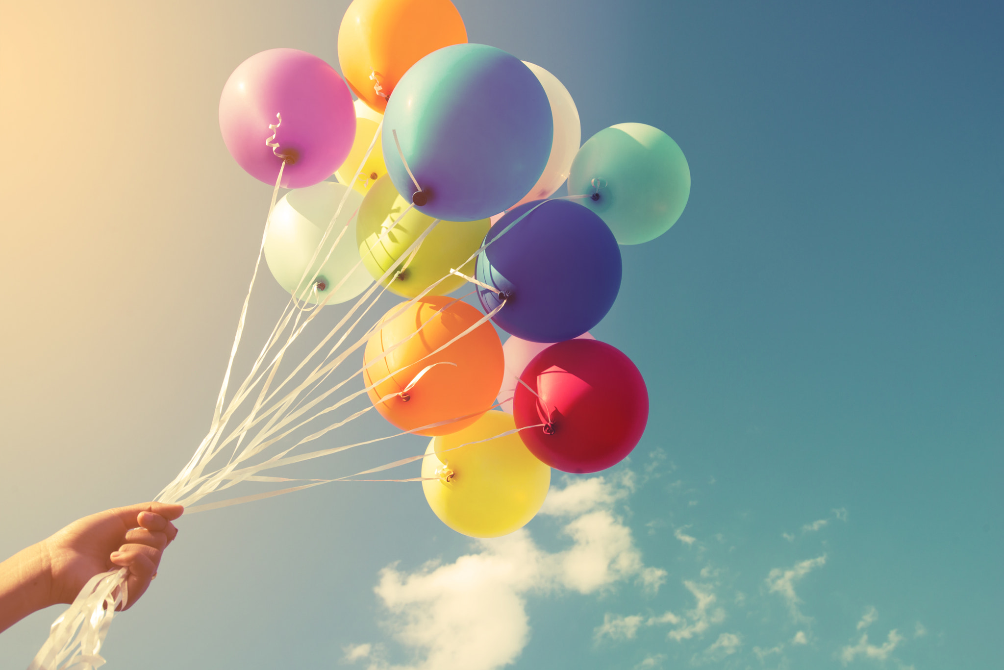 Nikon AF-S Nikkor 18-35mm F3.5-4.5G ED sample photo. Girl hand holding multicolor balloons done with a retro instagram filter effect, concept of happy... photography