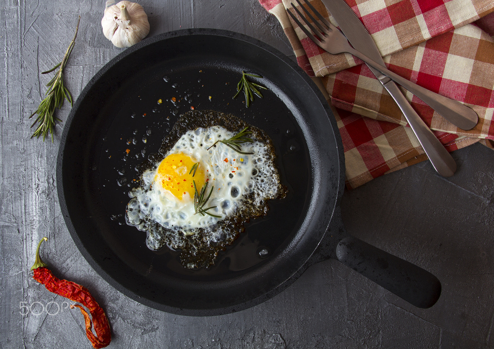 Canon EOS 60D + Canon EF 28-135mm F3.5-5.6 IS USM sample photo. Fried eggs iron frying pan rosemary spice pepper photography