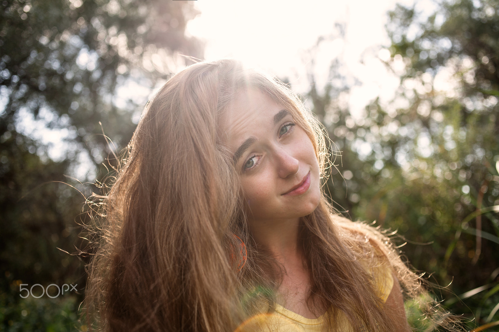 Canon EOS 5D + Canon EF 35mm F2 sample photo. Smiling girl posing in front of high trees in a park retro color backlit shot photography