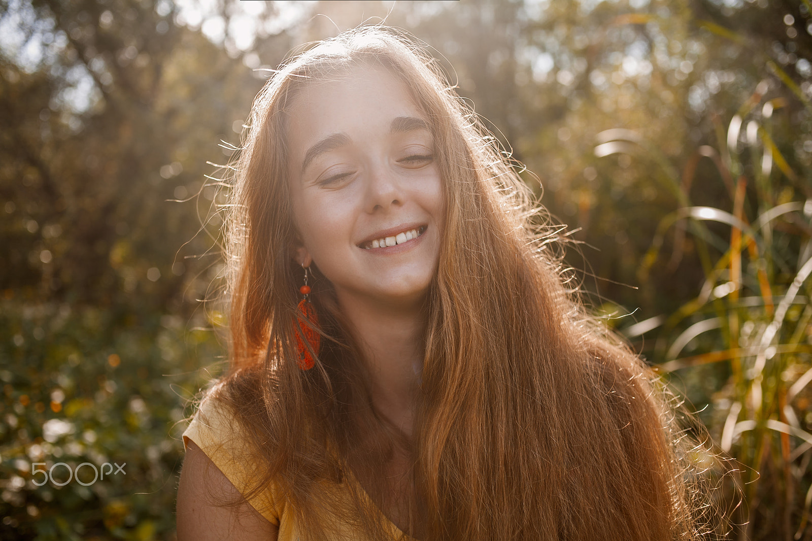 Canon EOS 5D + Canon EF 35mm F2 sample photo. Happy girl posing in front of high grass in a park with her eyes closed retro color photography