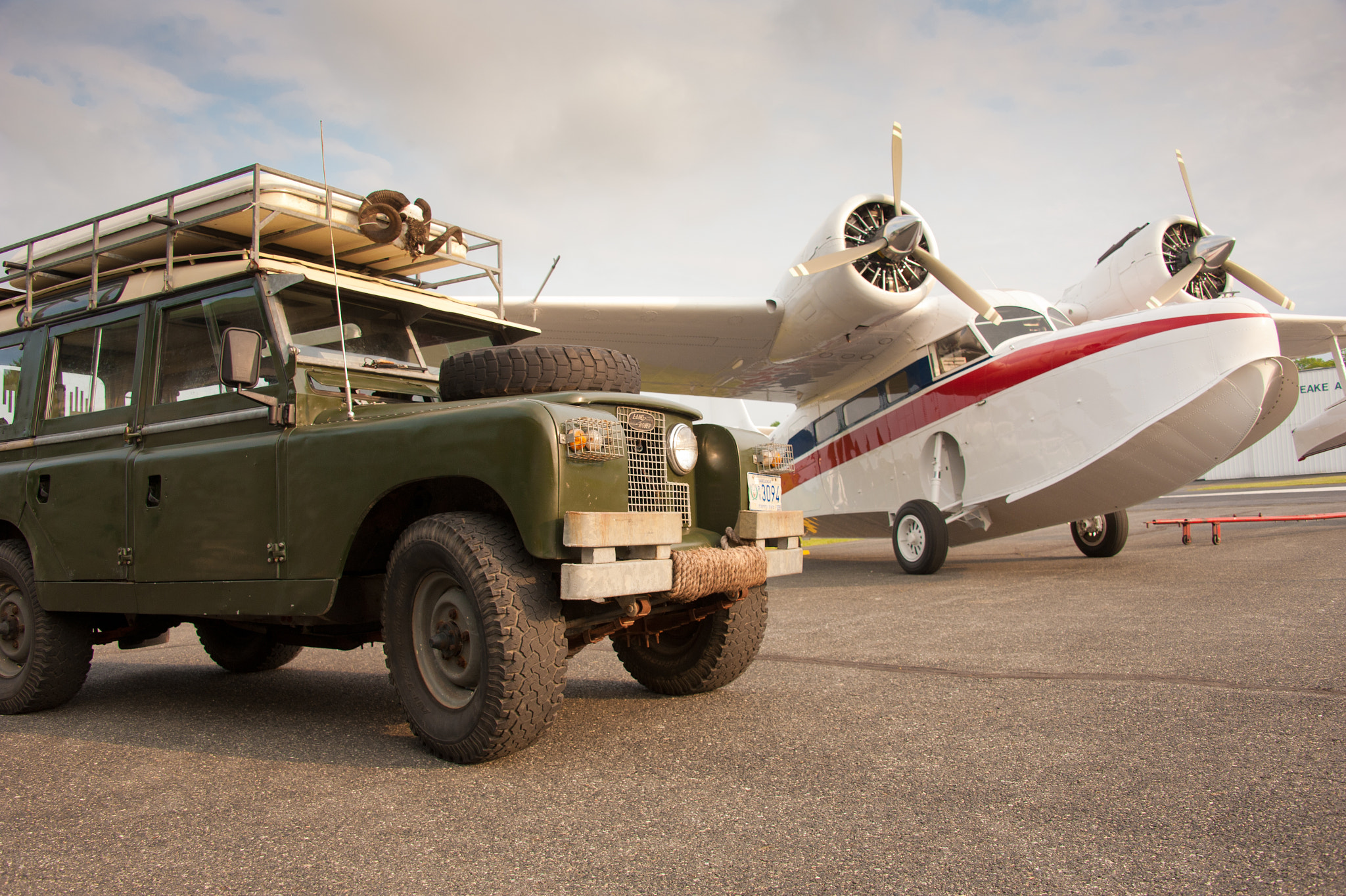 Nikon D700 sample photo. Grumman goose plane in airport next to series 2a 1966 land rover photography