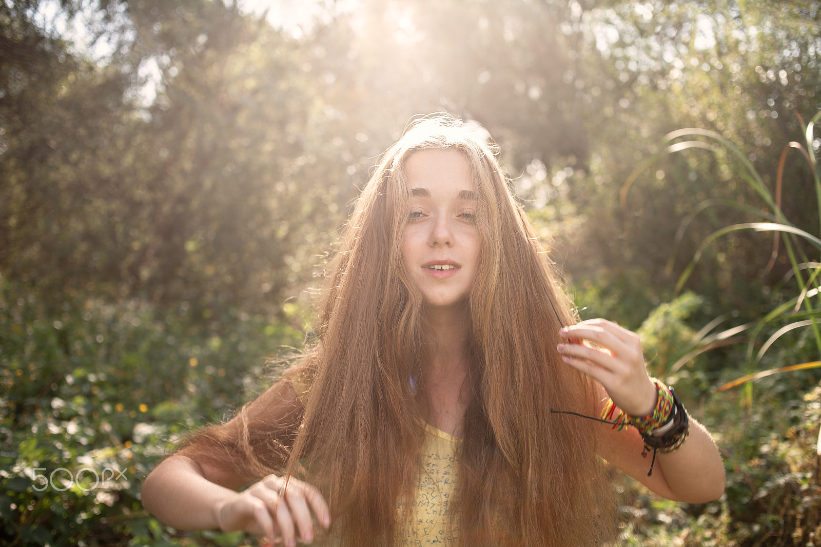 Canon EOS 5D + Canon EF 35mm F2 sample photo. Boho girl posing in front of high trees in a park retro color backlit shot photography