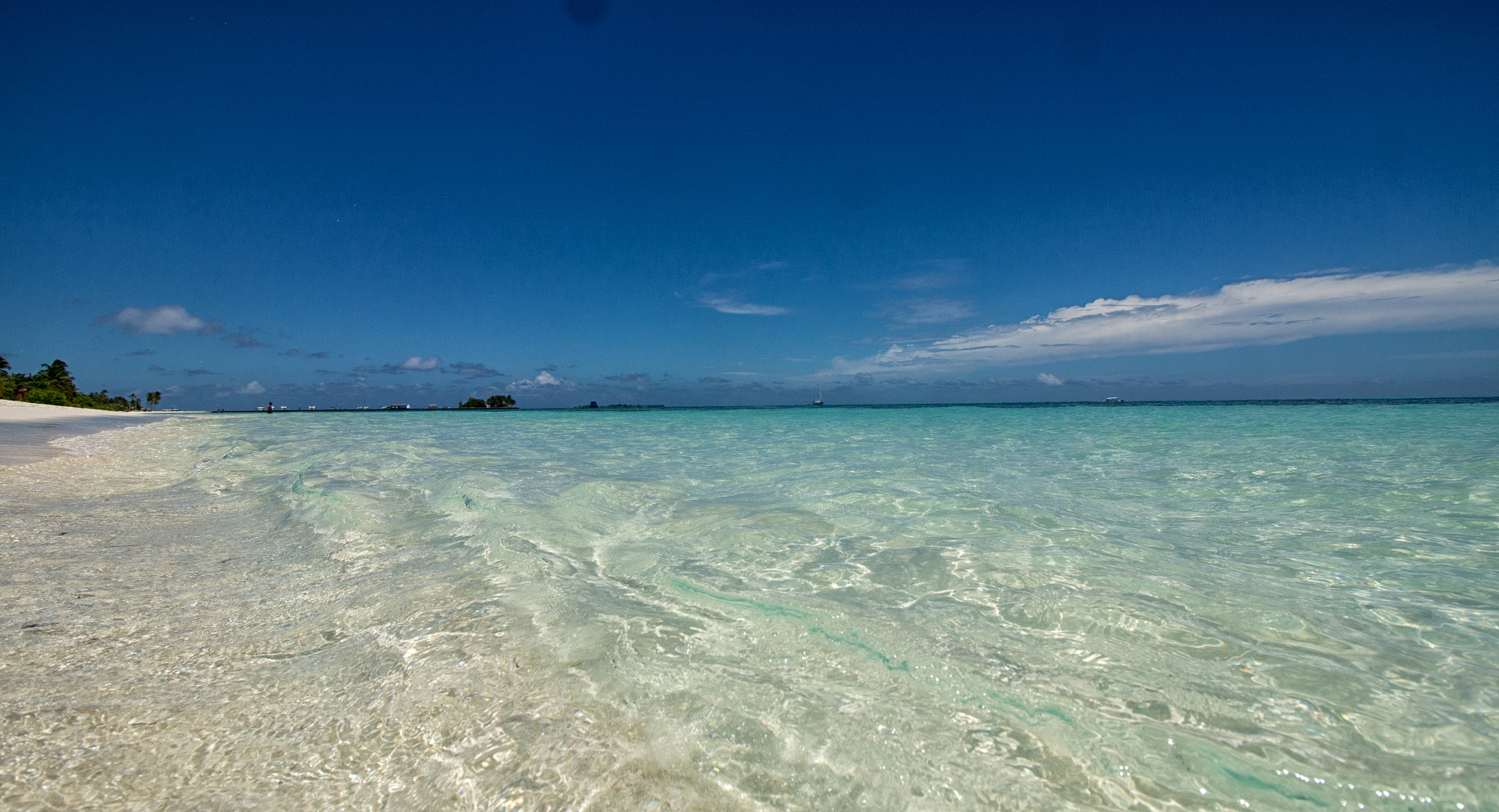 Canon EOS M sample photo. Waves lap the beach at kureudu, maldives photography