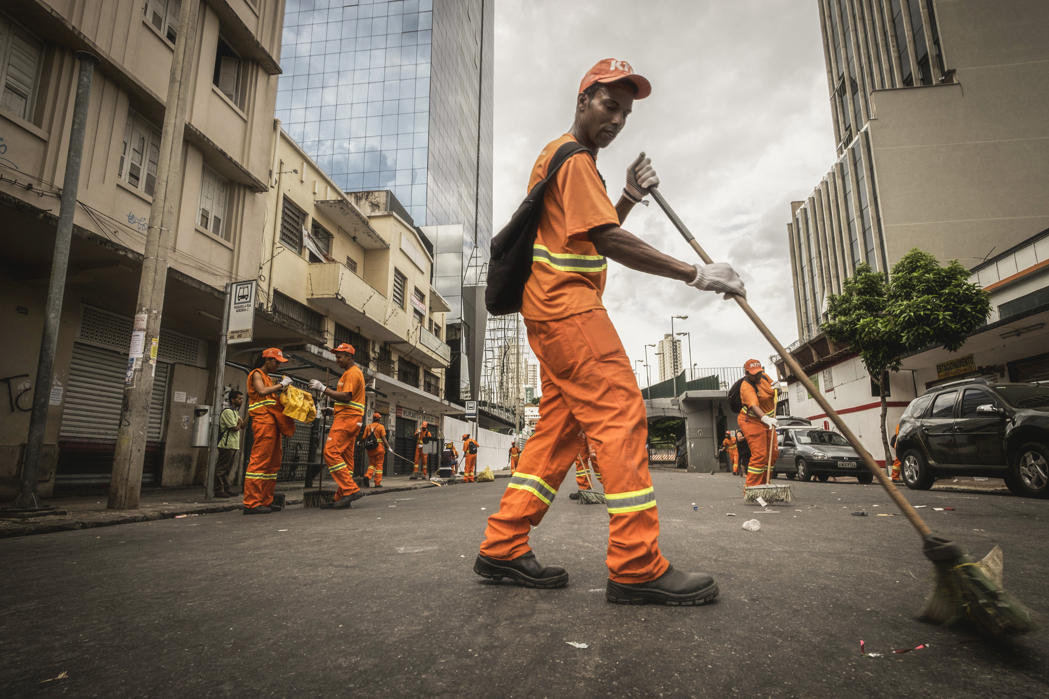 ZEISS Touit 12mm F2.8 sample photo. Workers on the streets after the carnival photography