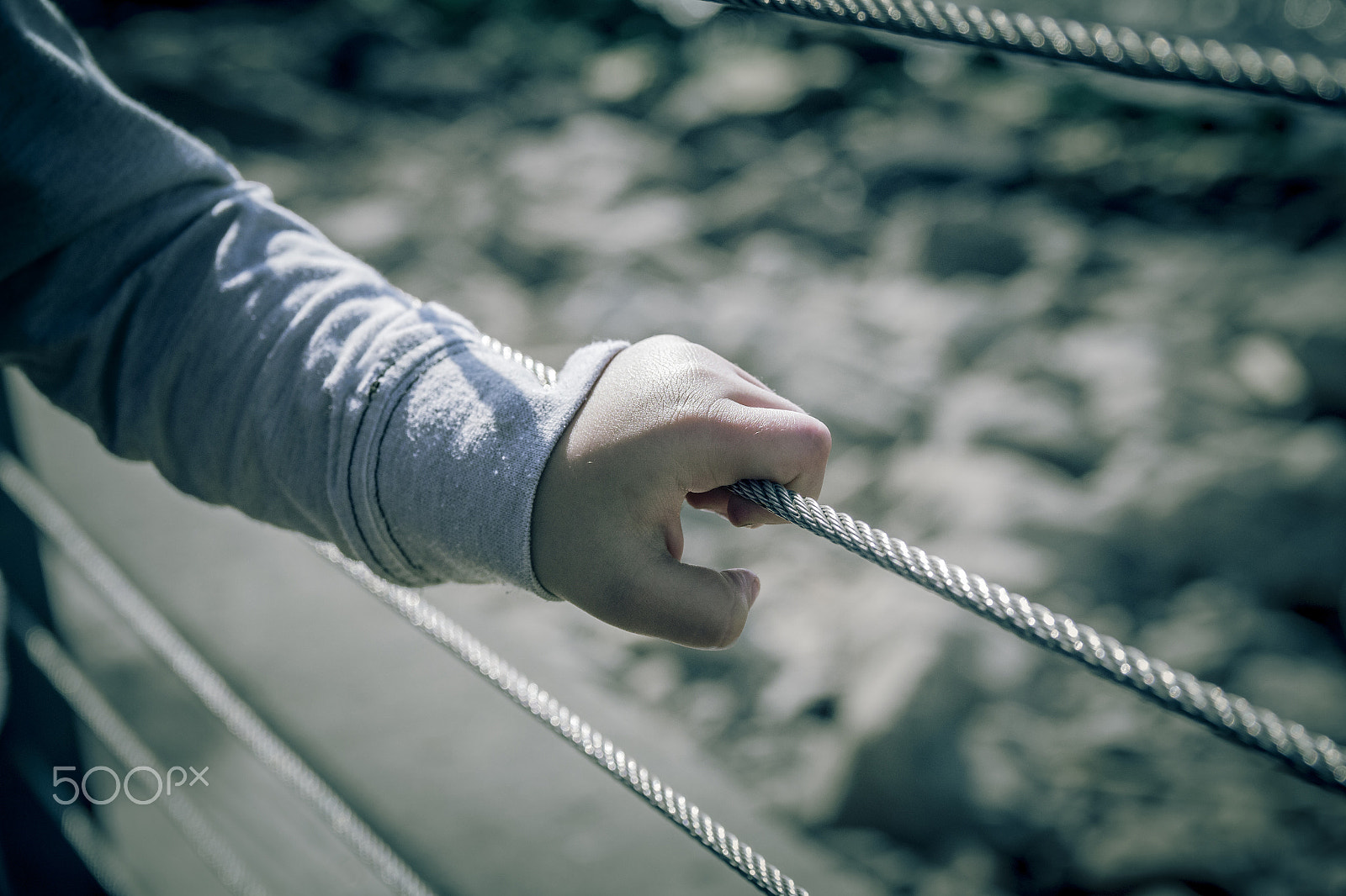 Canon EF-S 17-55mm F2.8 IS USM sample photo. Young boy hand holding metal wire fence photography